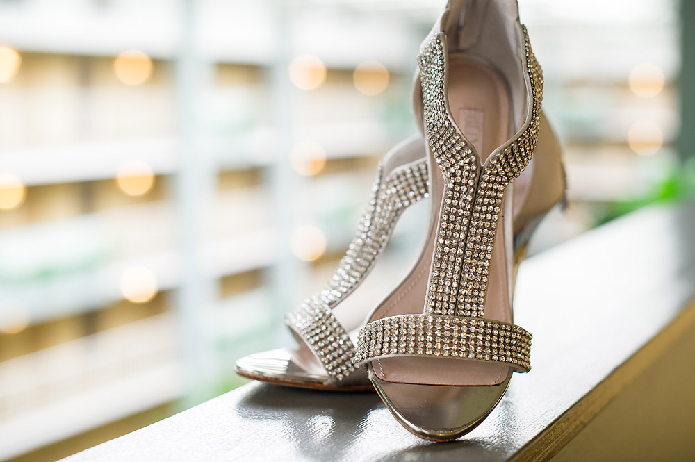 Rhinestone strappy bridal shoes on a window ledge