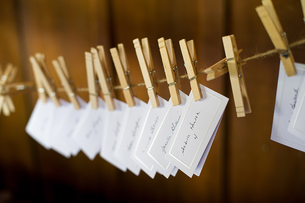 Handwritten escort cards clipped to twine