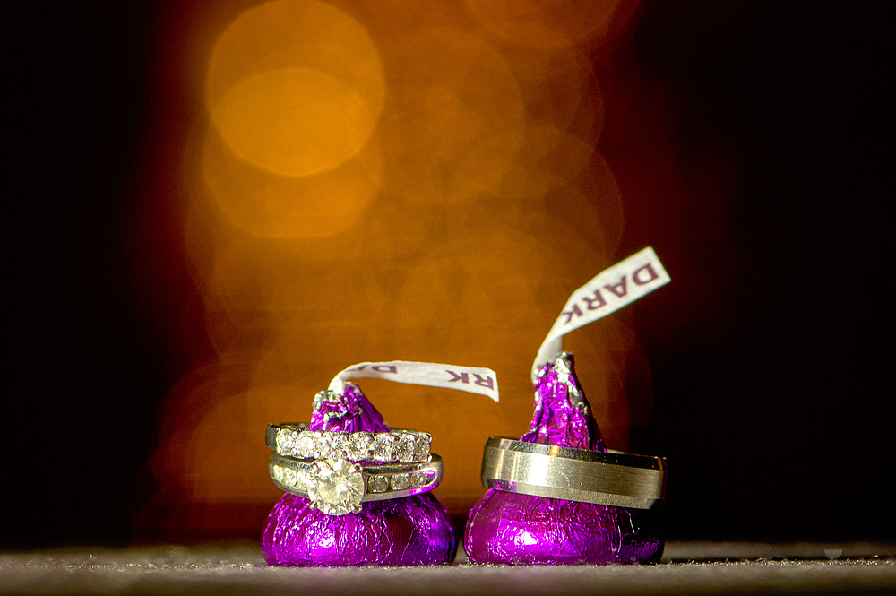 Wedding rings arranged on wrapped chocolates