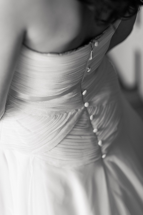 Black-and-white close-up of buttons on the back of a wedding dress