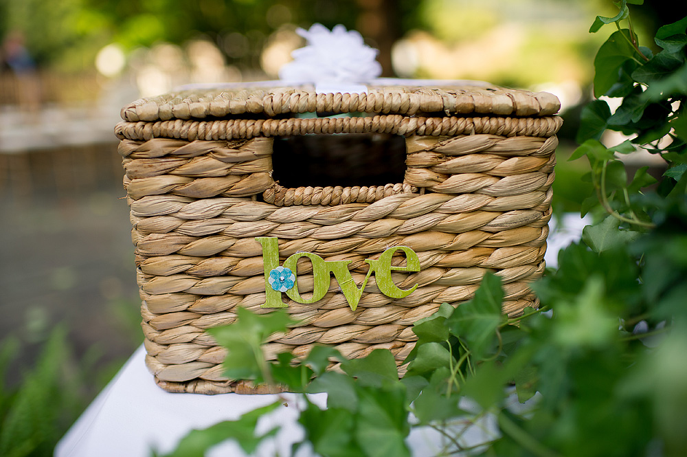 Woven wedding card basket decorated with a green love sign