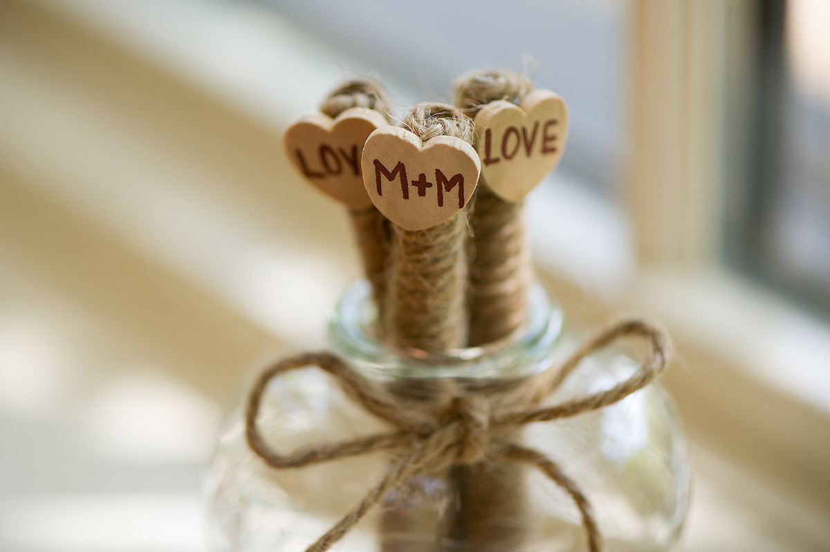 Rustic cork place-card holders topped with wooden hearts