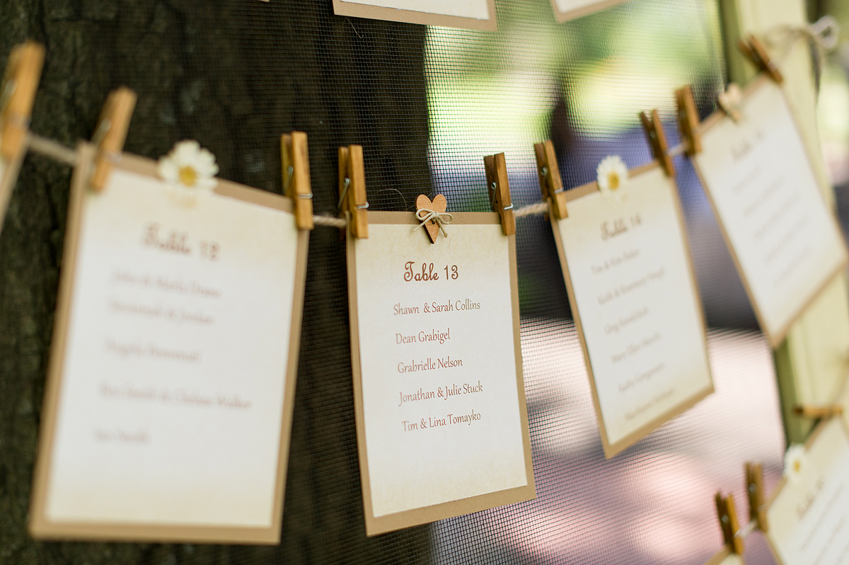 Escort cards clipped to twine with wooden clothespins