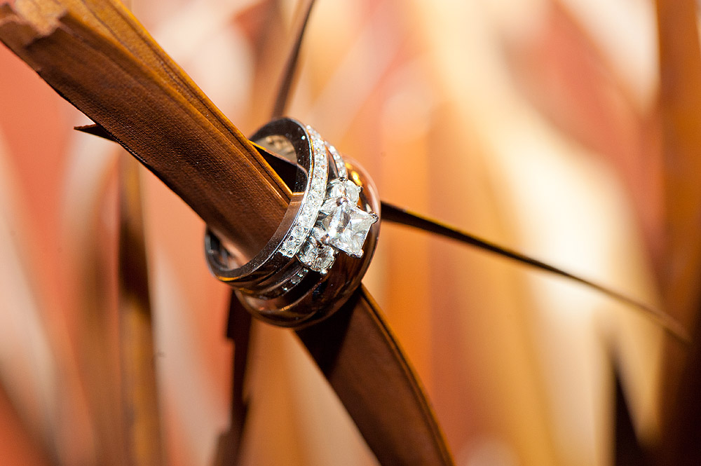 Wedding rings wrapped around a wooden chair detail