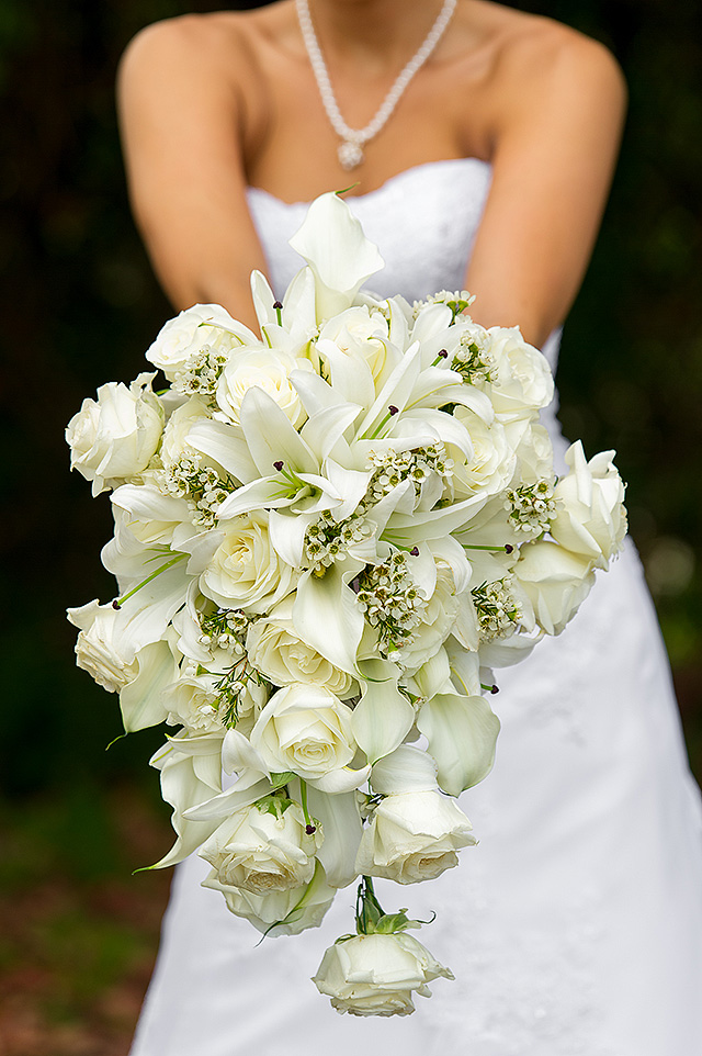 Cascading bouquet of white roses and greenery