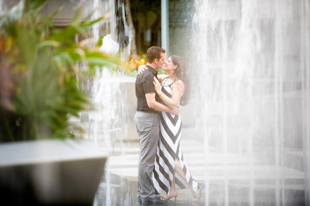 Couple kissing beside a cascading fountain
