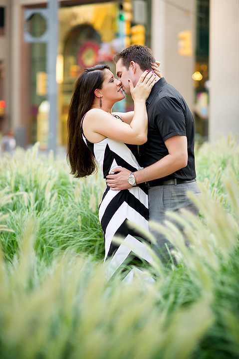 Couple kissing among tall ornamental grasses