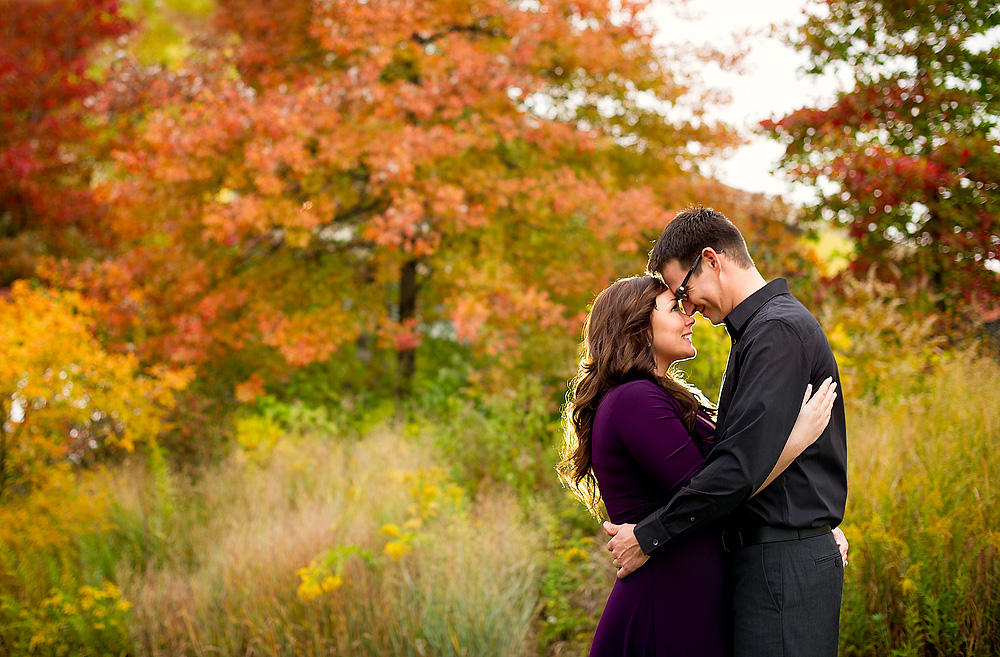 Couple embracing among bright autumn trees