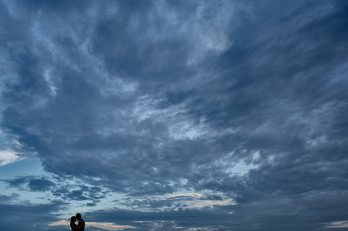Couple beneath a dramatic blue evening sky