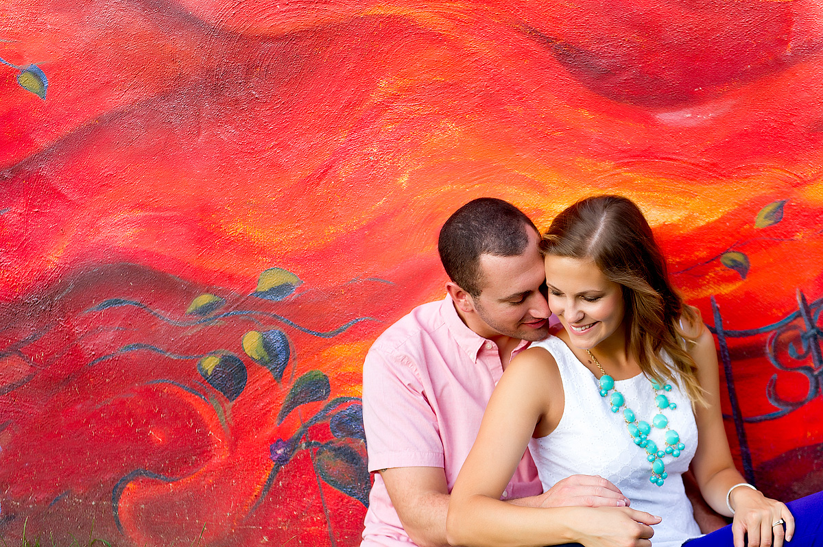 Couple seated before a colorful mural