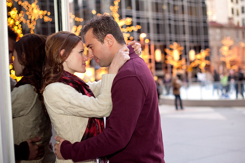 Couple embracing beside holiday lights in downtown Pittsburgh