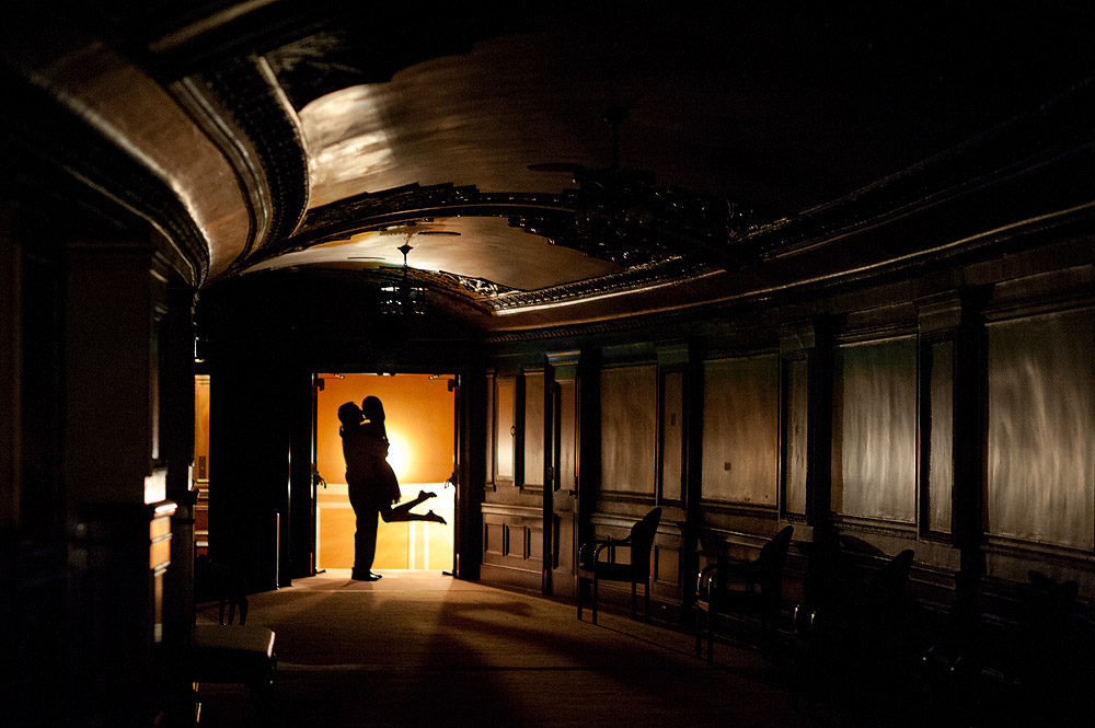 Couple silhouetted in the doorway of an industrial interior
