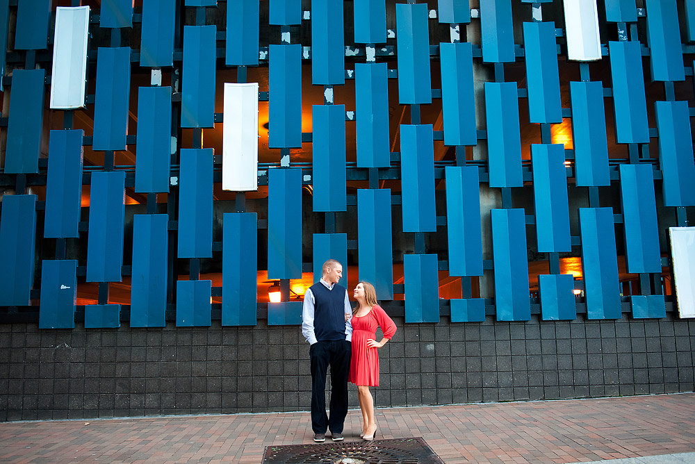 Couple standing before a blue geometric wall