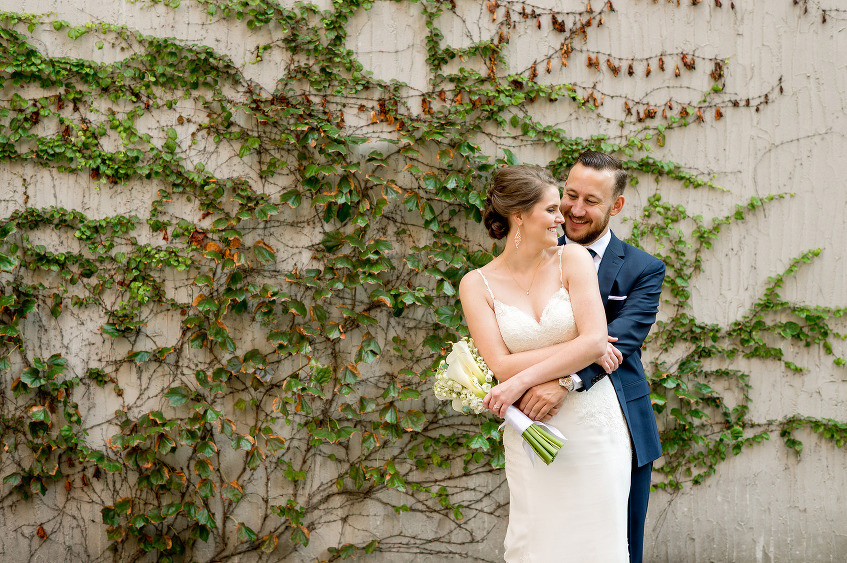 Bride and groom beside the ivy wall at the Renaissance Hotel Pittsburgh