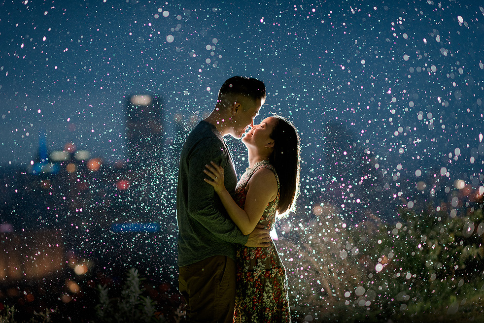 Backlit engagement portrait in the rain