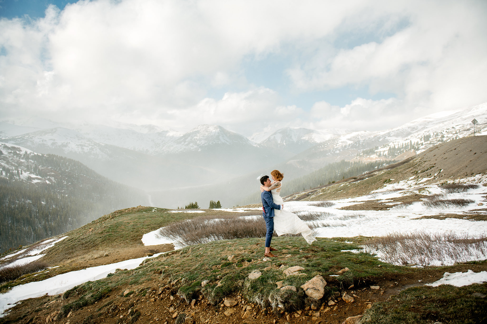 Wedding couple embracing in the snow-covered Colorado mountains