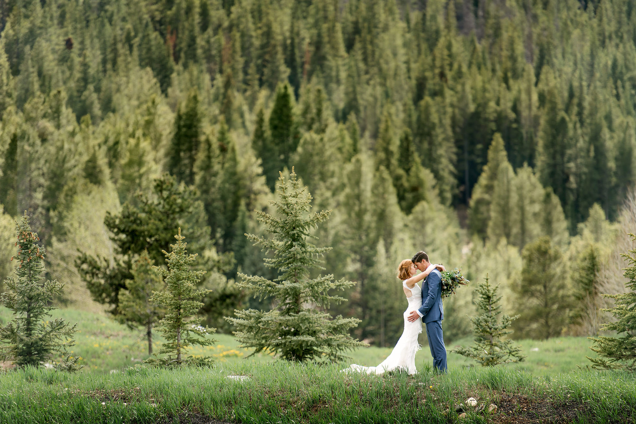 Wedding couple embracing in a Colorado mountain meadow