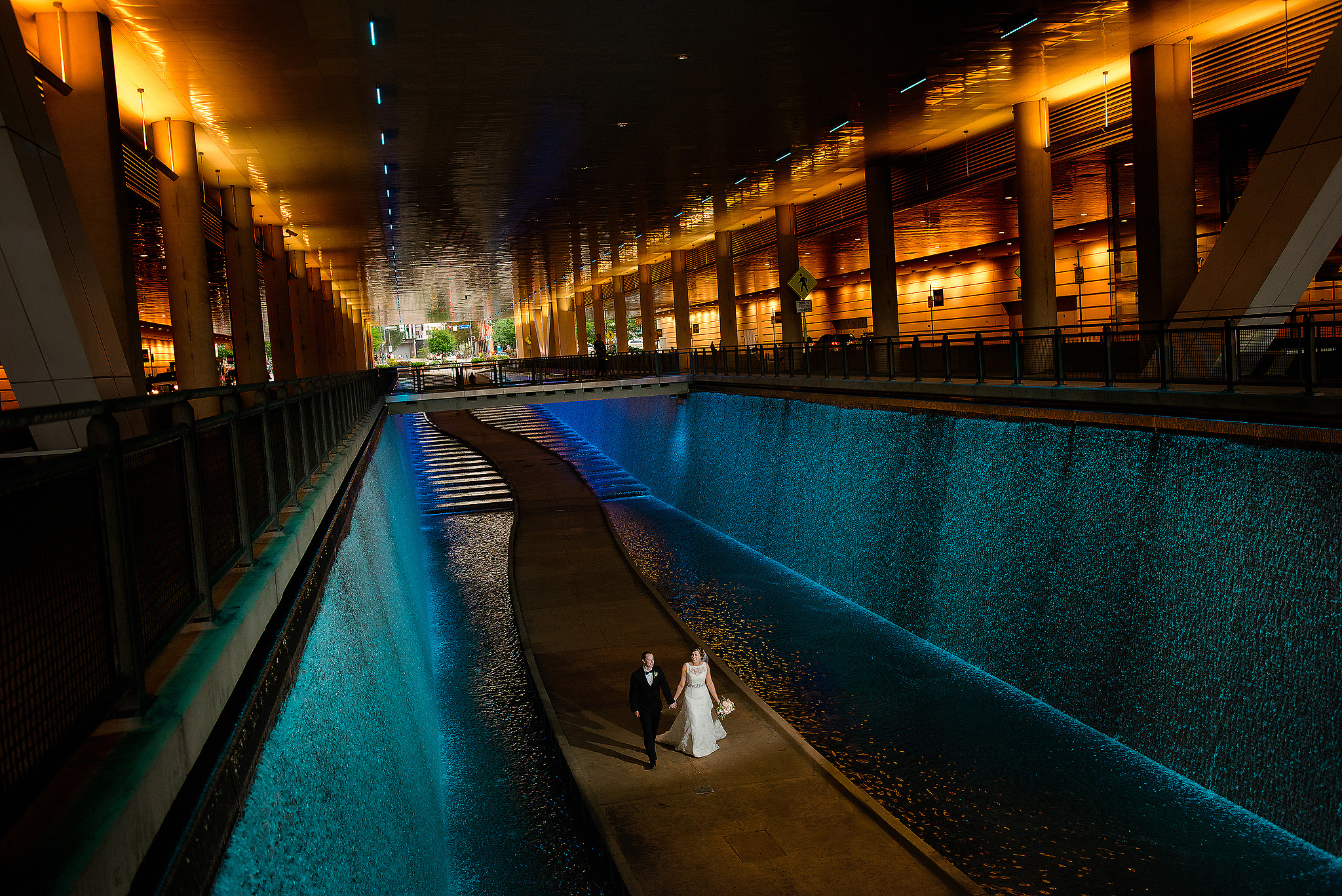 Newlyweds beneath the Pittsburgh Convention Center's illuminated exterior