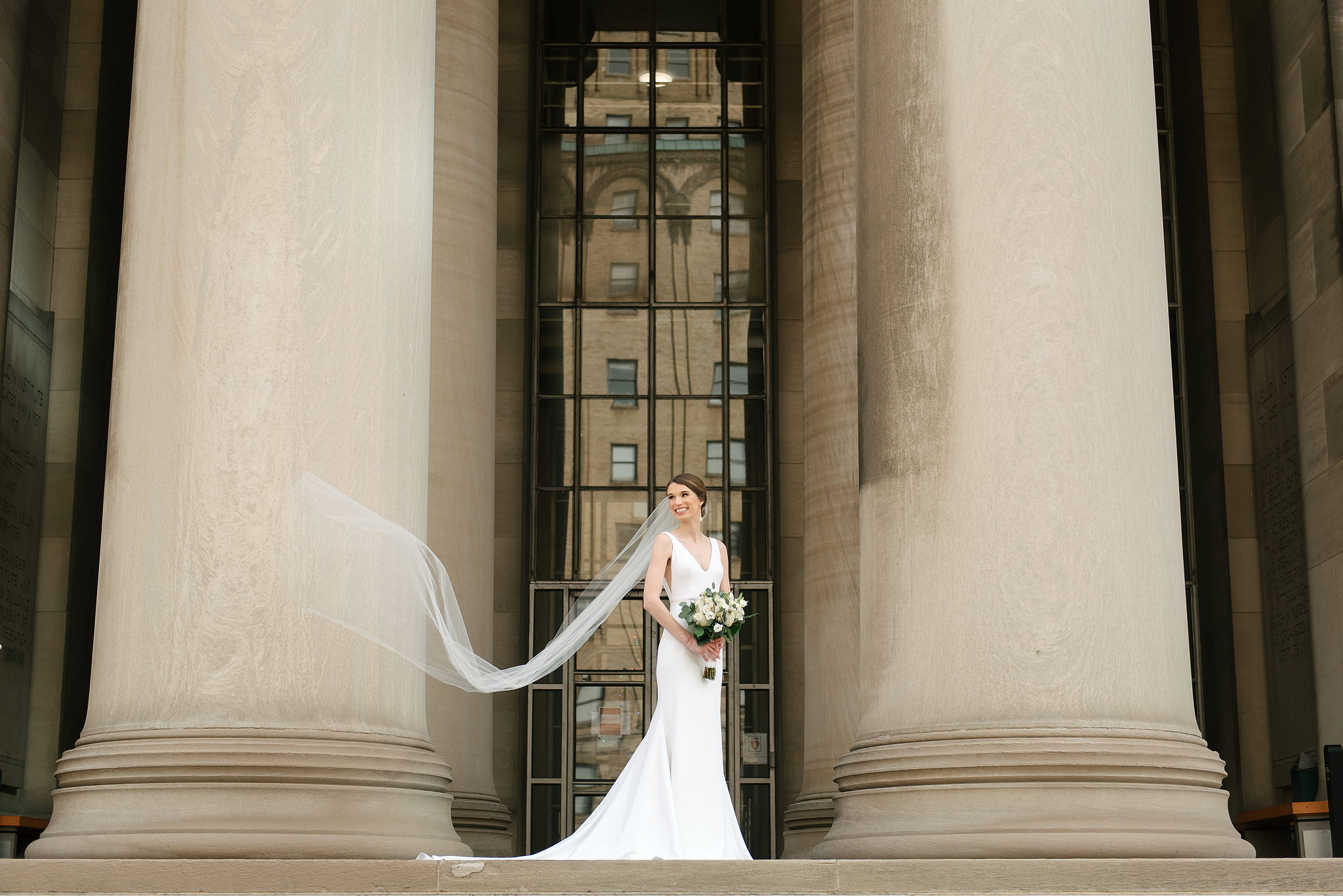 Bride beneath the Mellon Institute columns with her veil flowing