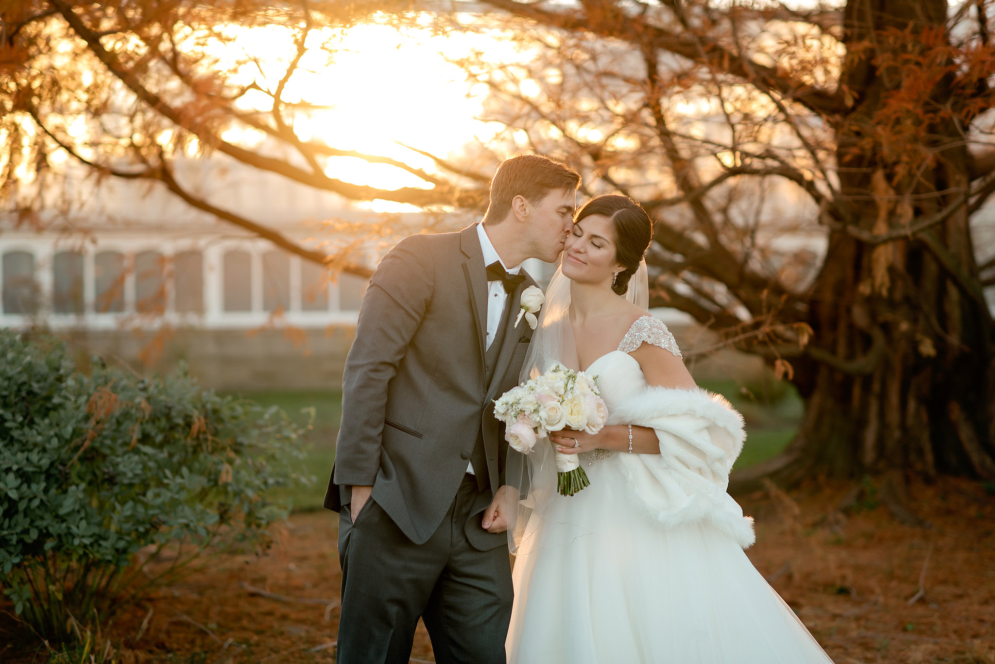 Wedding couple kissing at sunset outside Phipps Conservatory