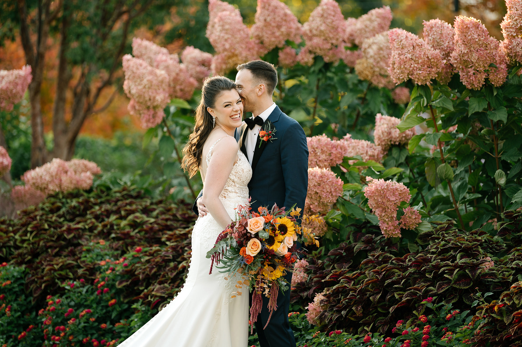 Newlyweds among flowers inside Phipps Conservatory